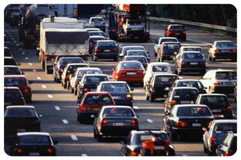 A traffic jam of cars in road traffic. Lots of cars in road traffic.